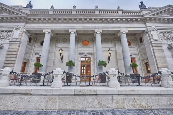 The colonnaded facade and café terrace of the Royal Guard building