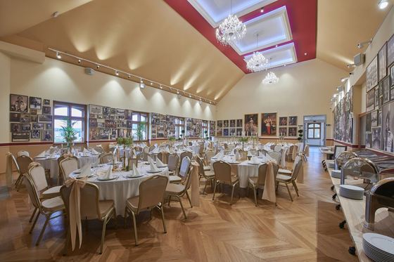 The Lipót Room set for an event, with chandeliers and round tables