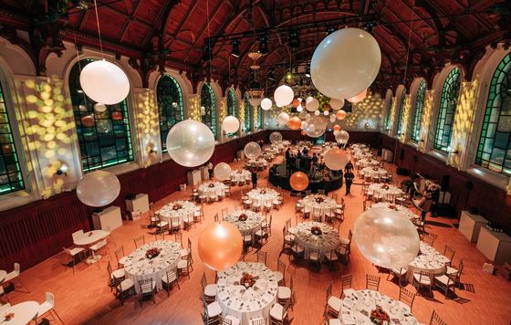 Evening gala dinner with hanging balloons in the riding hall